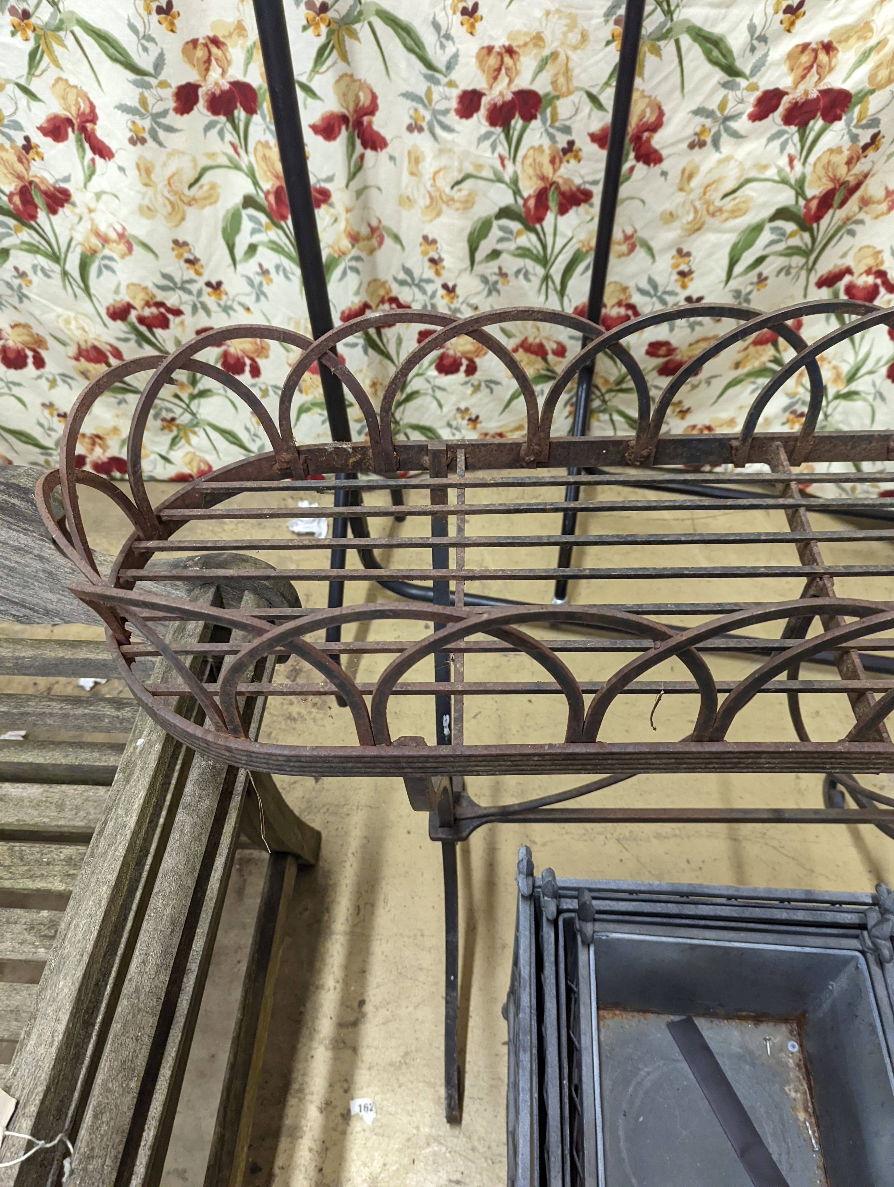 A Victorian style wrought iron pot stand, width 110cm, height 95cm, together with a graduated set of three square metal planters